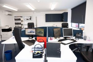 interior of office showing 4 new desks and new kitchen installed by Howdens