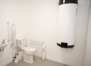 Interior Disabled toilet featuring sustainable heating pump